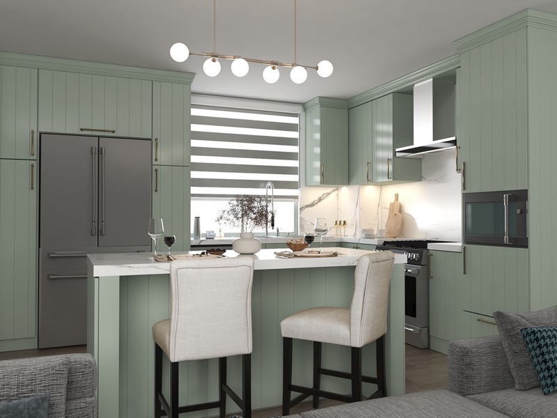 Sage green custom kitchen cabinets with a white island and bar stools