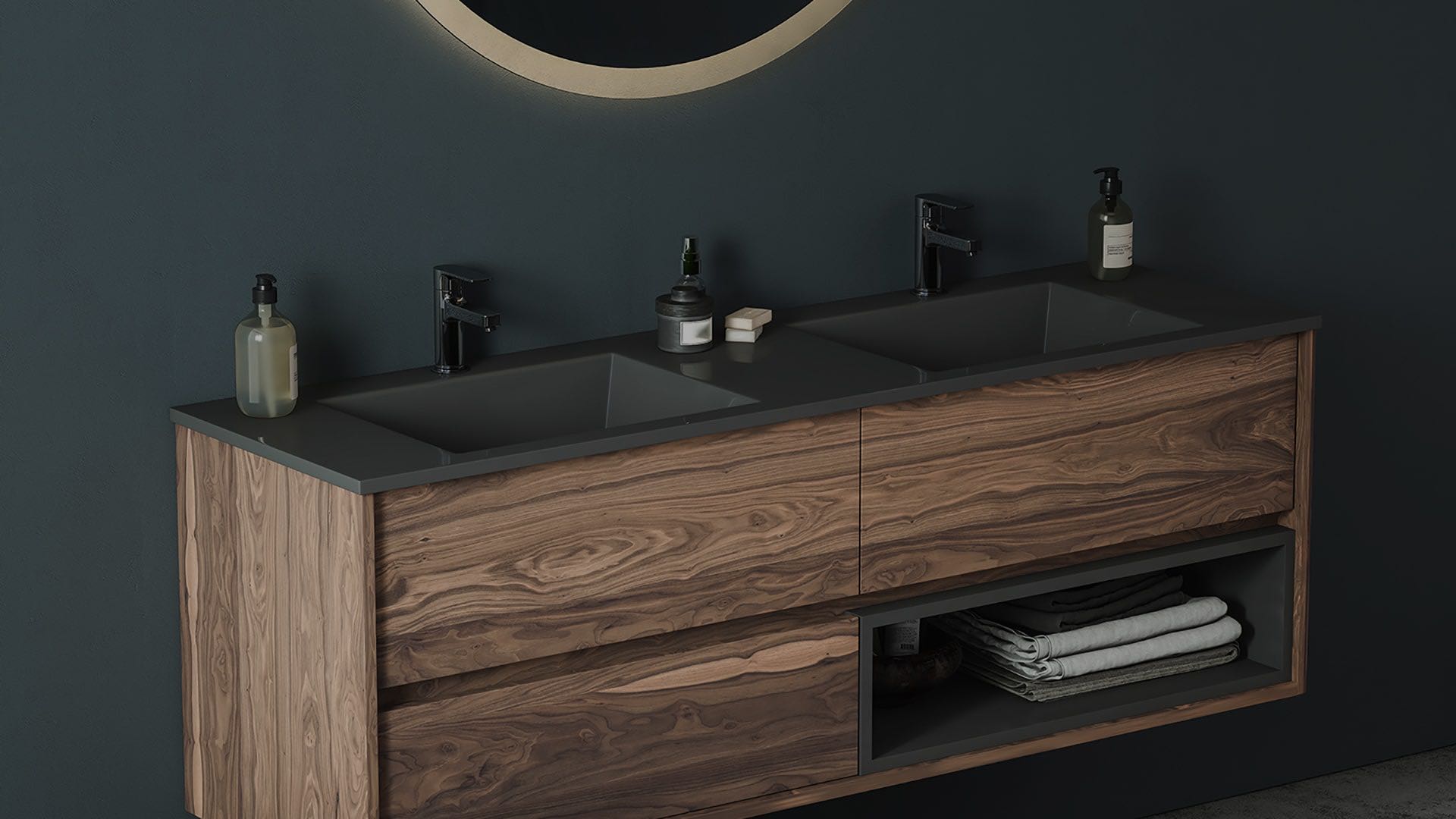 Wood double vanity with dark countertop and round mirror