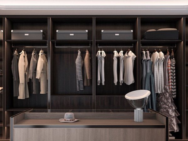 Dark wood open wardrobe with hanging rails and a central island