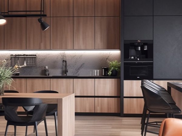 Hotel suite kitchenette with wood-grain cabinets, black tall units and a dining counter