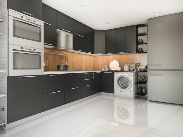 Charcoal grey kitchen cabinets with a warm wood backsplash and built-in appliances