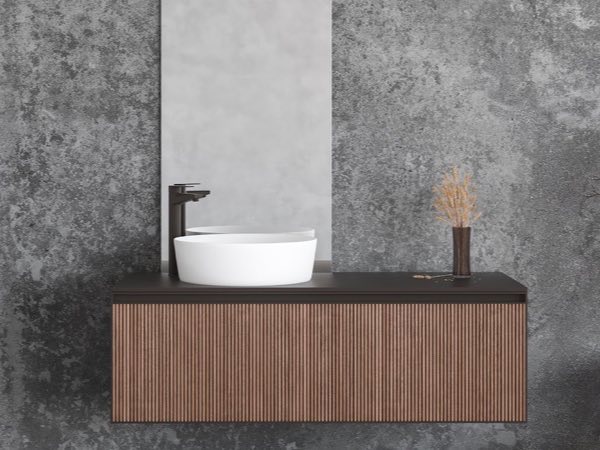 Walnut fluted floating vanity against a concrete-look wall