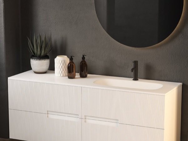 White fluted vanity with an integrated basin